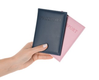 Photo of Woman holding passports in color covers on white background, closeup