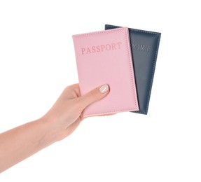 Photo of Woman holding passports in color covers on white background, closeup