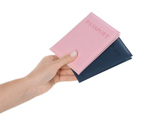 Photo of Woman holding passports in color covers on white background, closeup