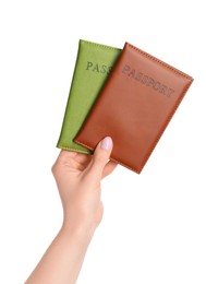 Photo of Woman holding passports in color covers on white background, closeup