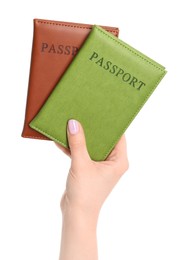 Photo of Woman holding passports in color covers on white background, closeup