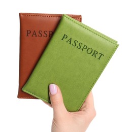 Photo of Woman holding passports in color covers on white background, closeup