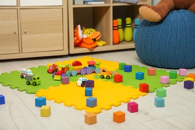 Photo of Colorful cubes and other toys in kid's room