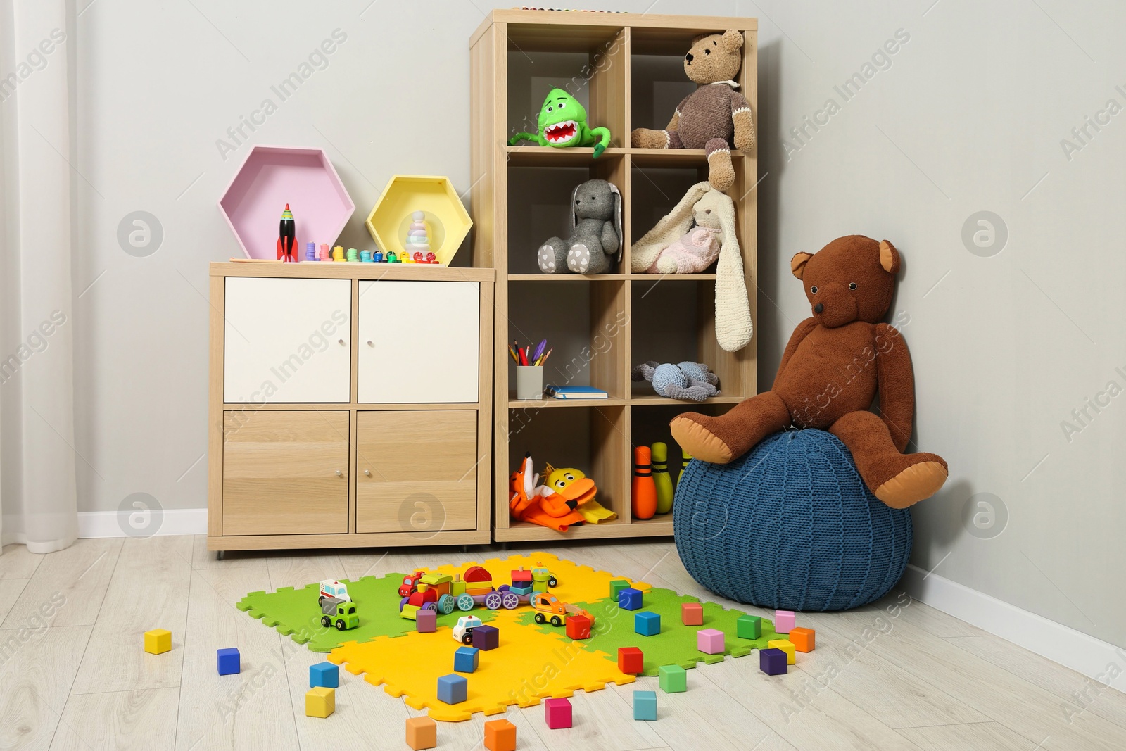 Photo of Beautiful kid's room interior with toys and stylish furniture