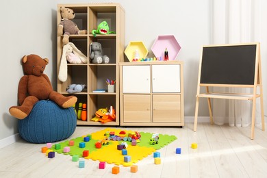 Photo of Beautiful kid's room interior with toys and stylish furniture