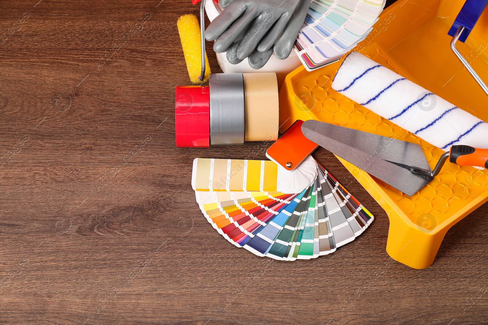 Photo of Different painter's tools on wooden table, space for text. Decorating and design