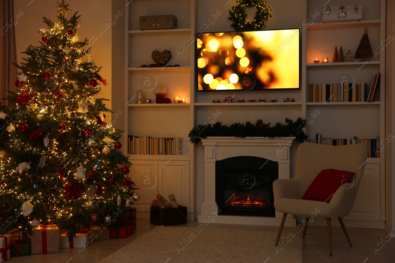 Photo of Beautifully decorated Christmas tree near fireplace in room. Festive interior design