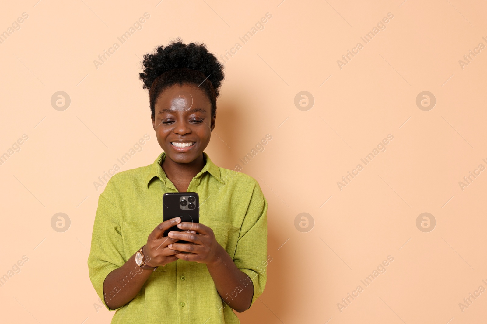 Photo of Happy woman with smartphone on beige background. Space for text