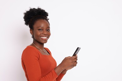 Photo of Happy woman with smartphone on white background. Space for text