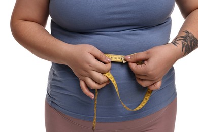 Photo of Weight loss. Plus size woman measuring waist with tape on white background, closeup