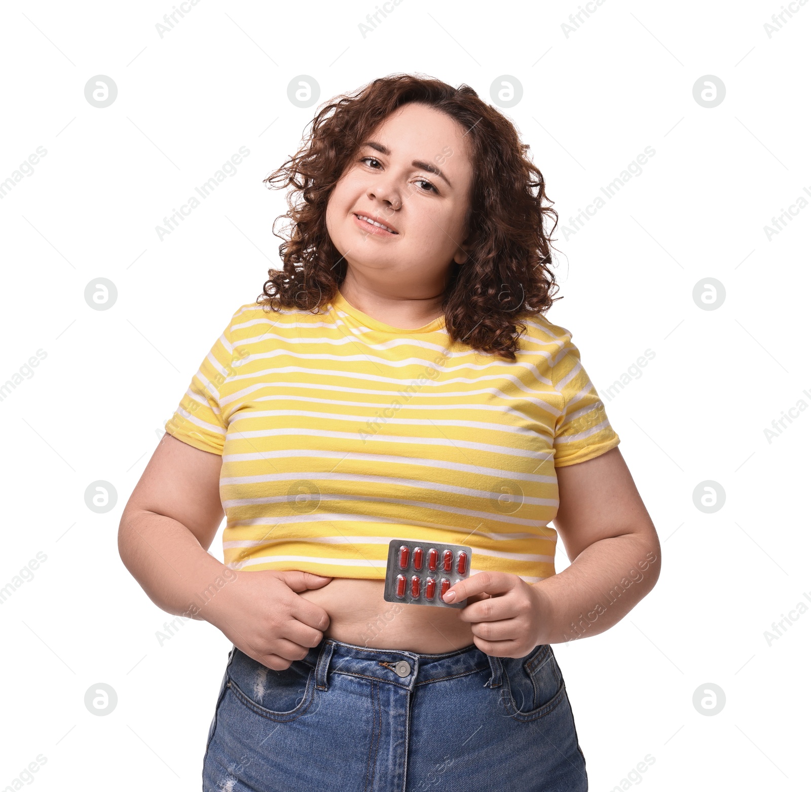 Photo of Happy plus size woman with blister of weight loss supplements on white background