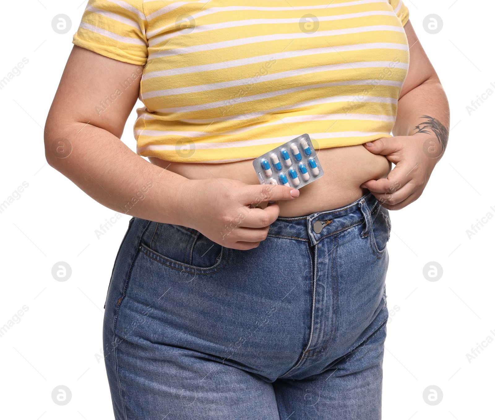 Photo of Plus size woman holding blister of weight loss supplements on white background, closeup