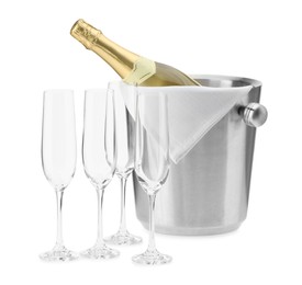 Photo of Bottle of champagne in ice bucket and empty glasses isolated on white