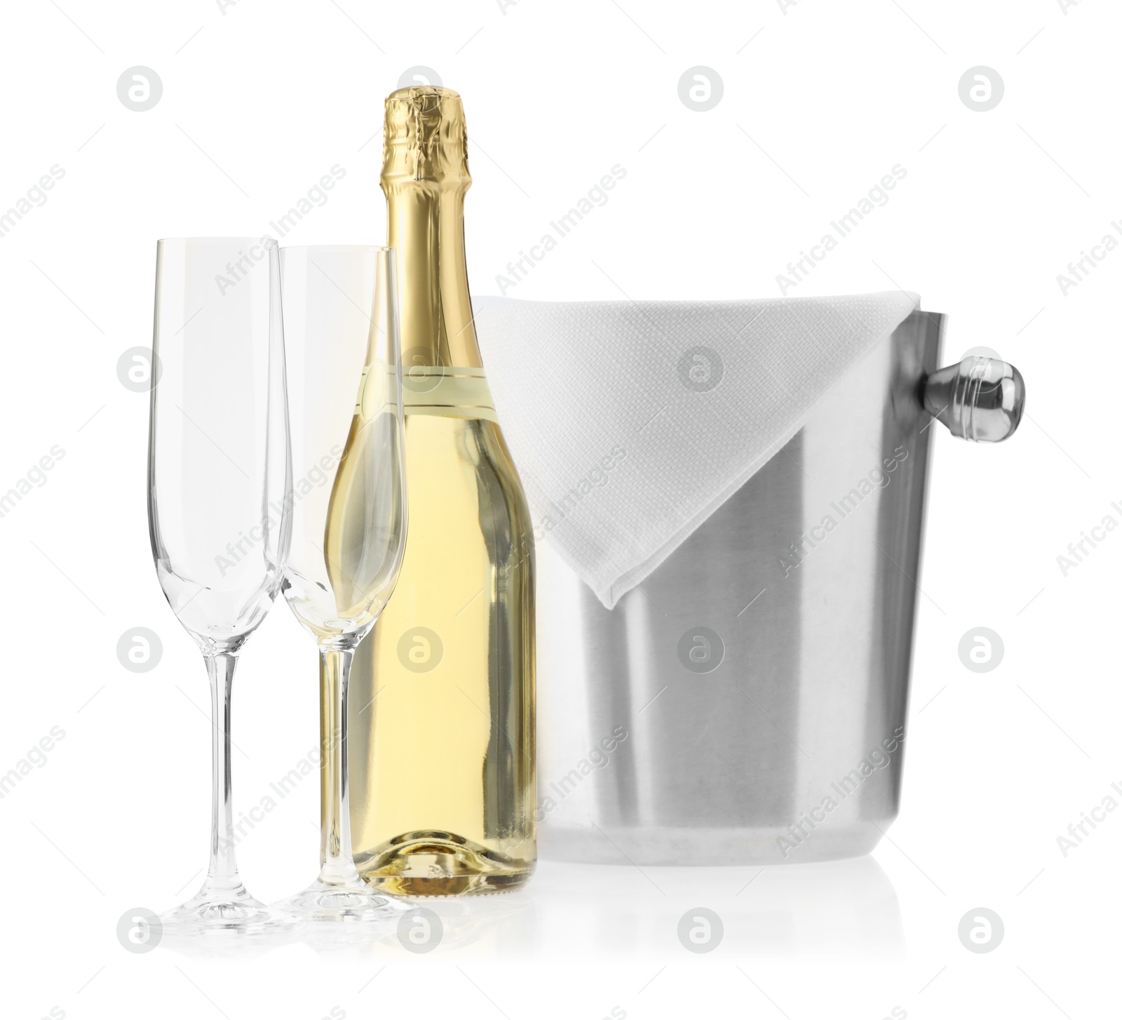 Photo of Bottle of champagne, ice bucket and empty glasses isolated on white