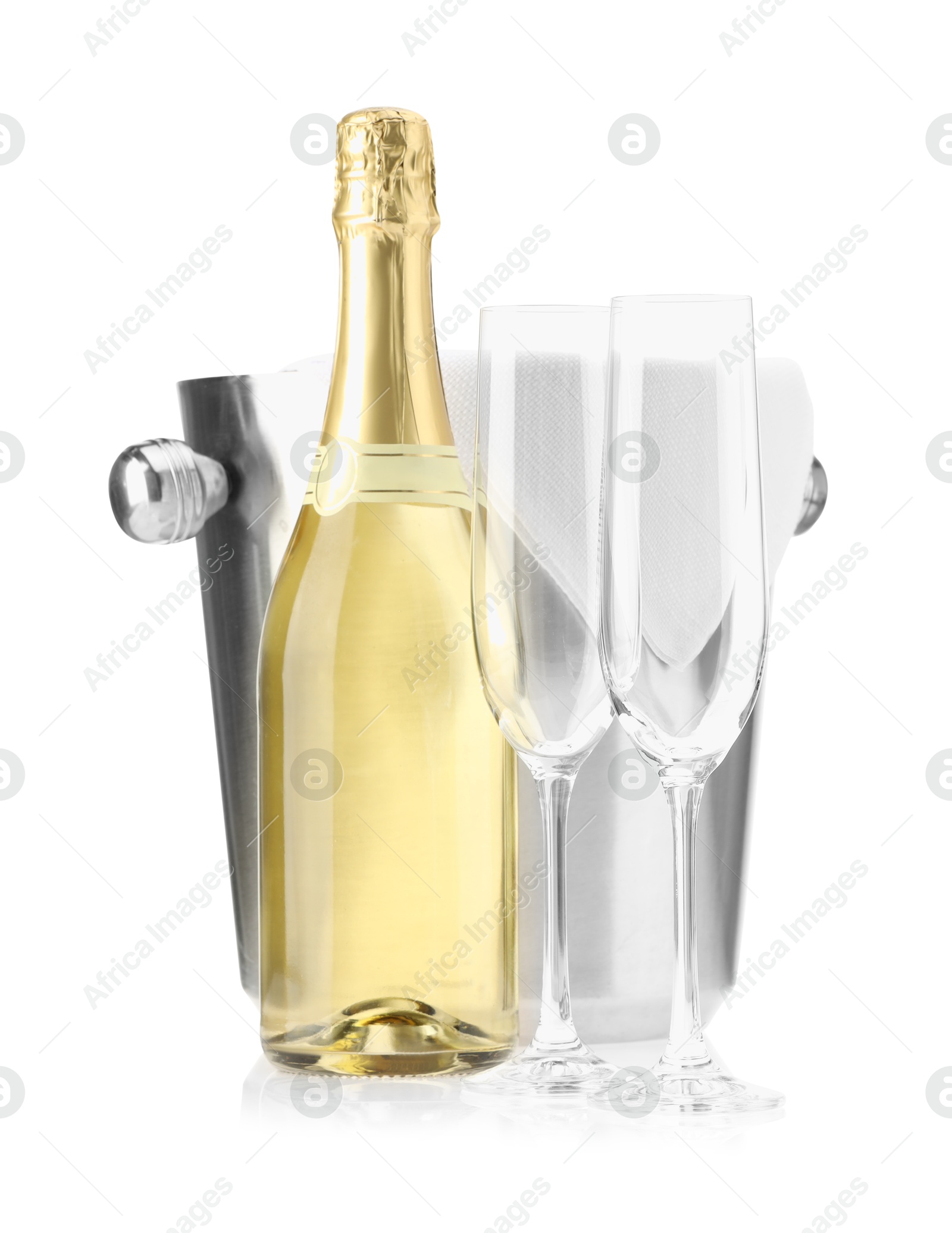 Photo of Bottle of champagne, ice bucket and empty glasses isolated on white