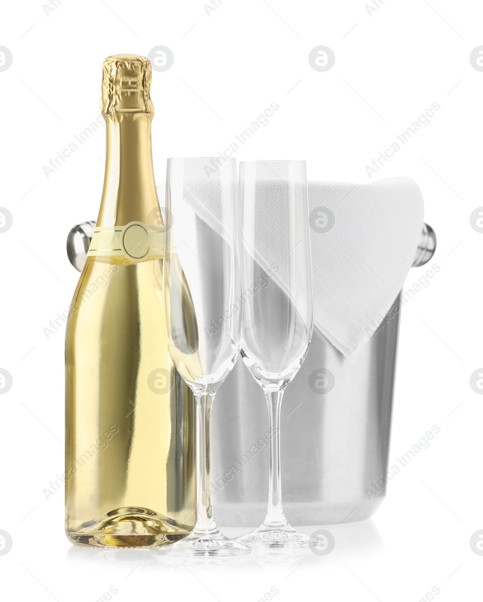 Photo of Bottle of champagne, ice bucket and empty glasses isolated on white