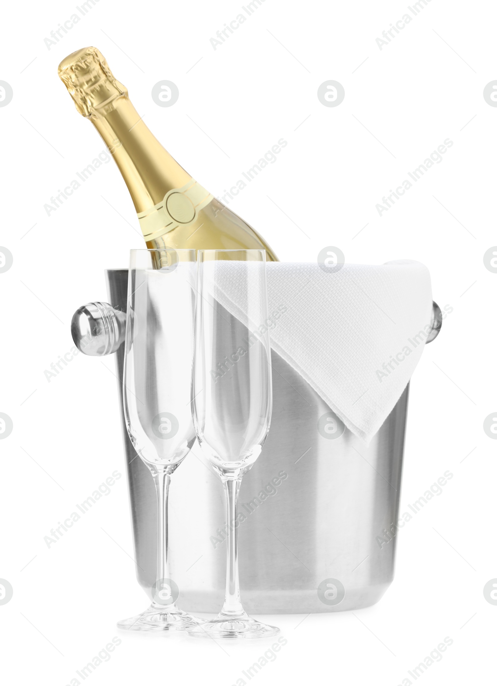 Photo of Bottle of champagne in ice bucket and empty glasses isolated on white