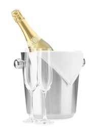 Photo of Bottle of champagne in ice bucket and empty glasses isolated on white