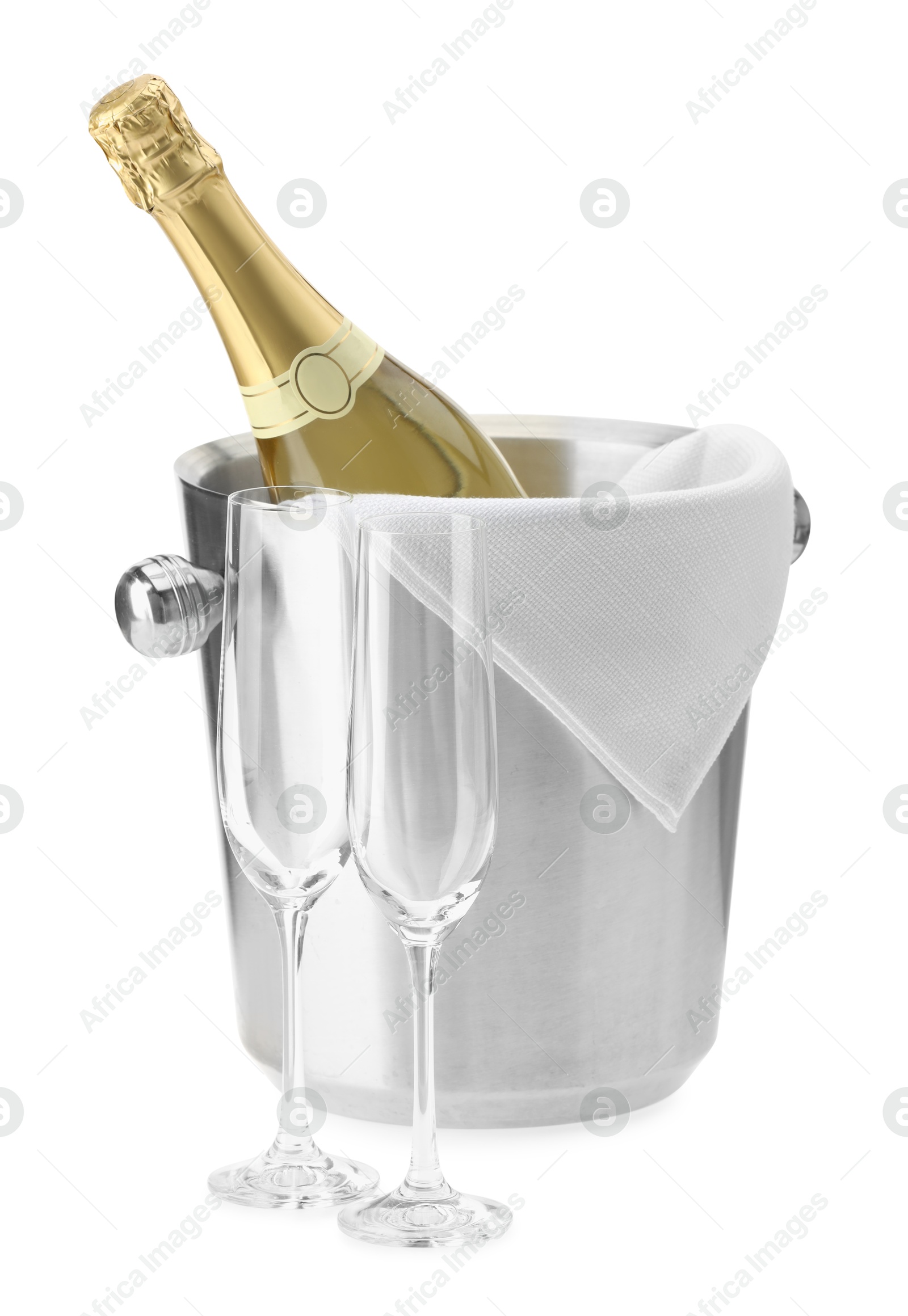 Photo of Bottle of champagne in ice bucket and empty glasses isolated on white