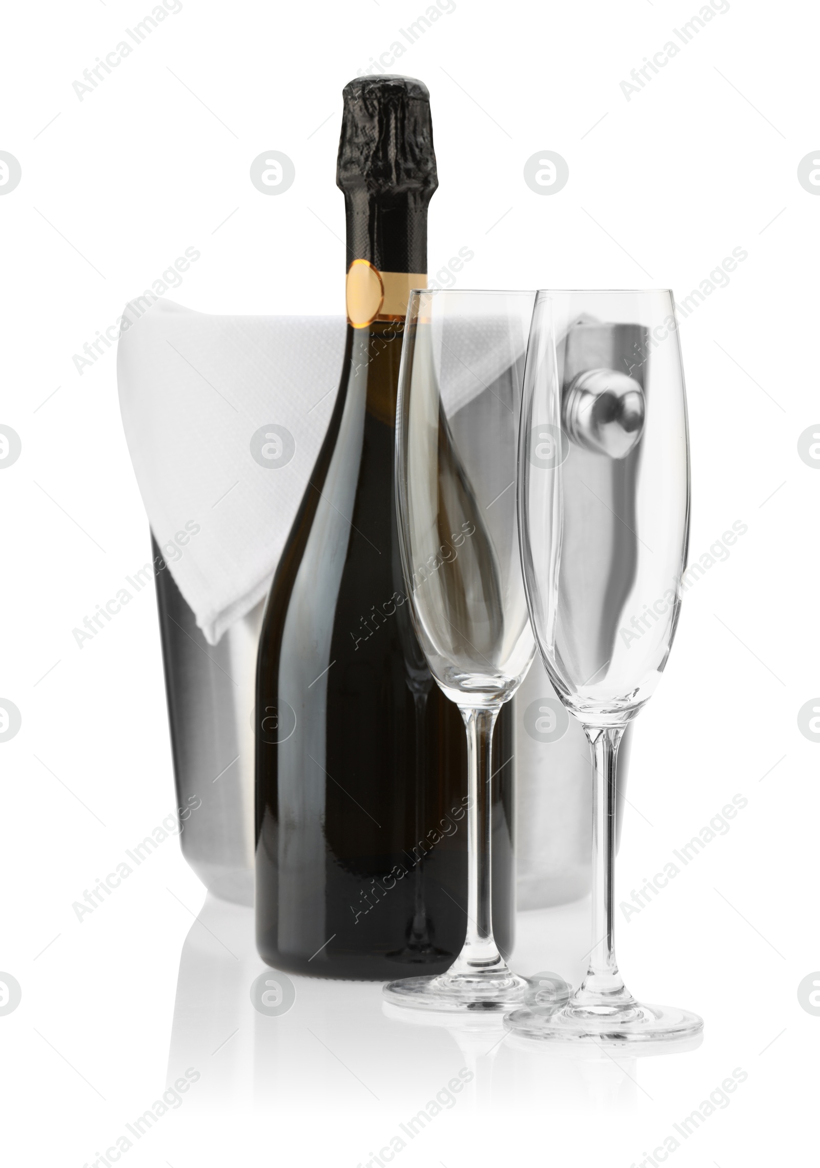 Photo of Bottle of champagne, empty glasses and ice bucket isolated on white