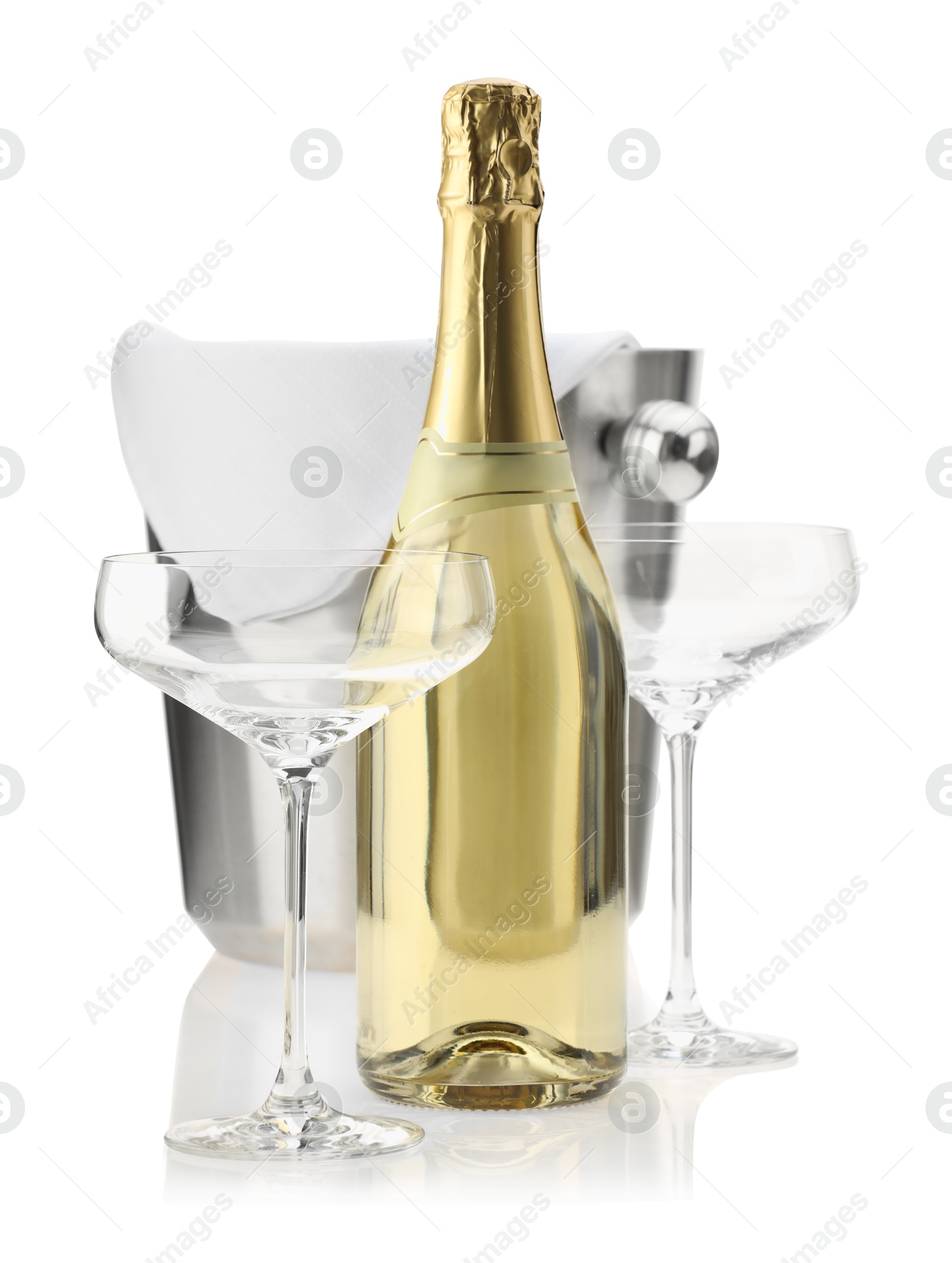 Photo of Bottle of champagne, empty glasses and ice bucket isolated on white