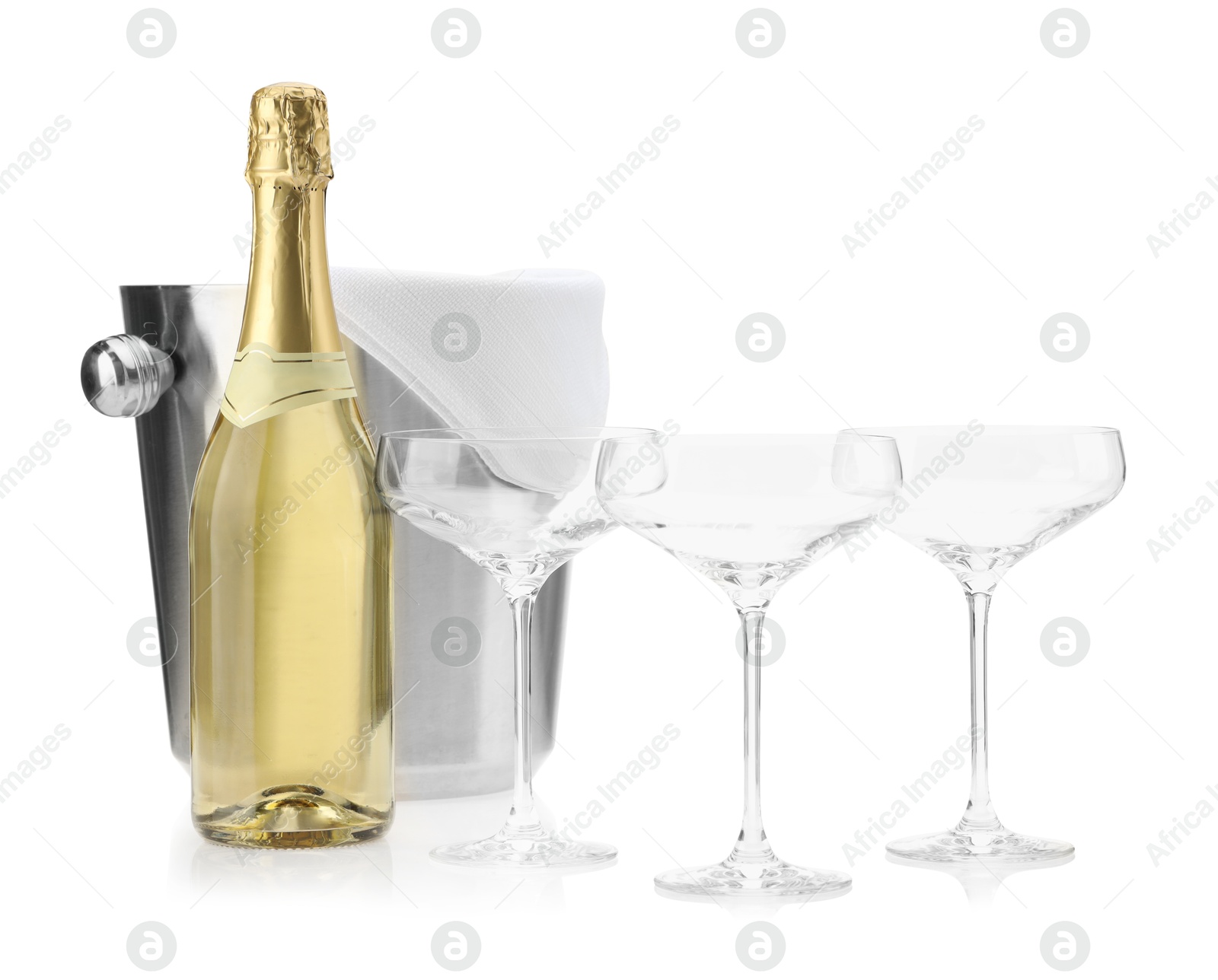 Photo of Bottle of champagne, empty glasses and ice bucket isolated on white