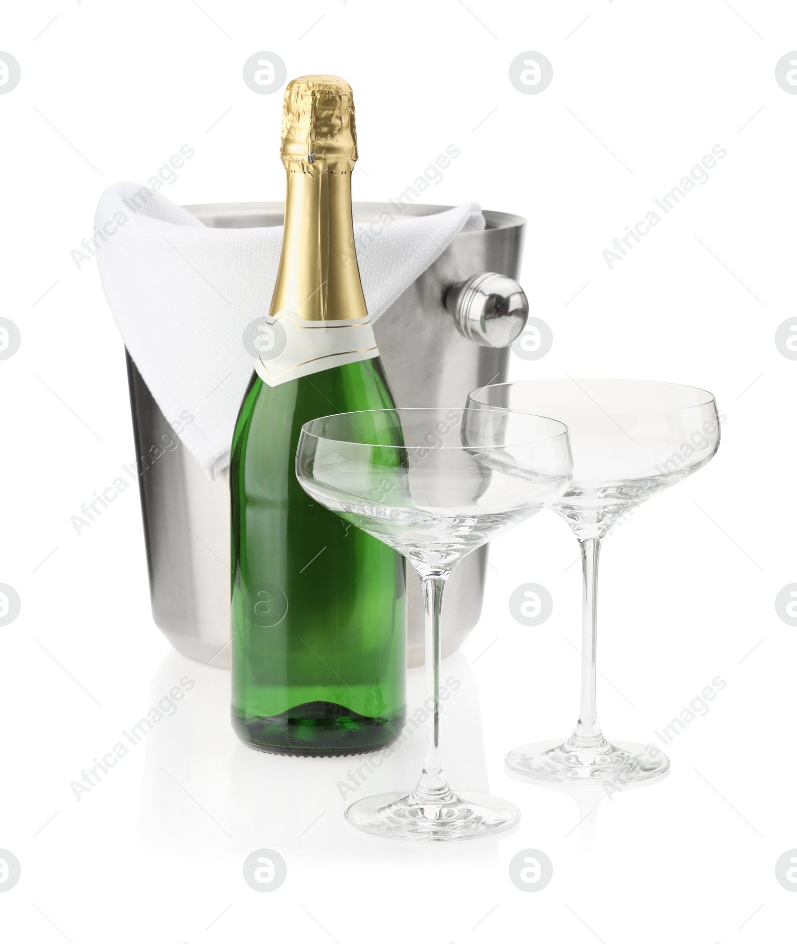 Photo of Bottle of champagne, empty glasses and ice bucket isolated on white