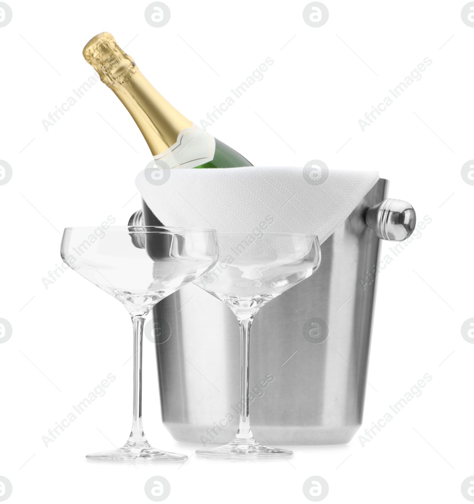 Photo of Bottle of champagne in ice bucket and empty glasses isolated on white