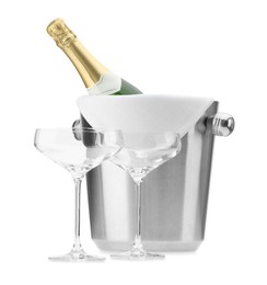 Photo of Bottle of champagne in ice bucket and empty glasses isolated on white