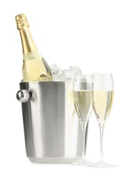 Photo of Champagne in glasses and ice bucket with bottle isolated on white