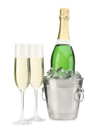 Photo of Champagne in glasses and ice bucket with bottle isolated on white