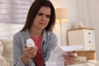 Photo of Woman with pills reading instruction at home