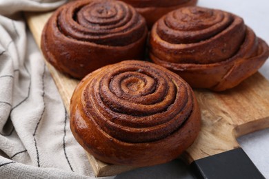 Photo of Delicious cinnamon roll buns on table, closeup