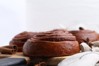 Photo of Delicious cinnamon roll buns on table, closeup