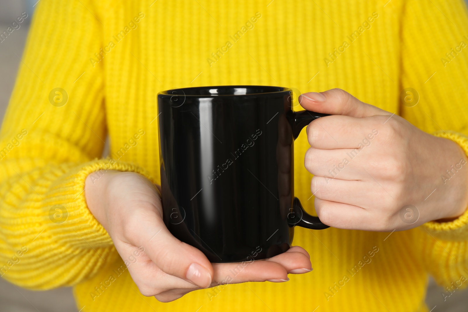 Photo of Woman with black ceramic cup, closeup. Mockup for design