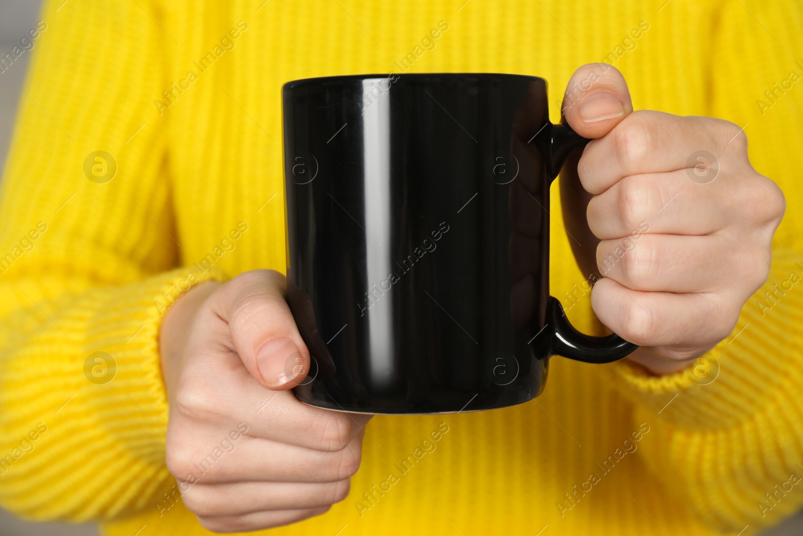 Photo of Woman with black ceramic cup, closeup. Mockup for design