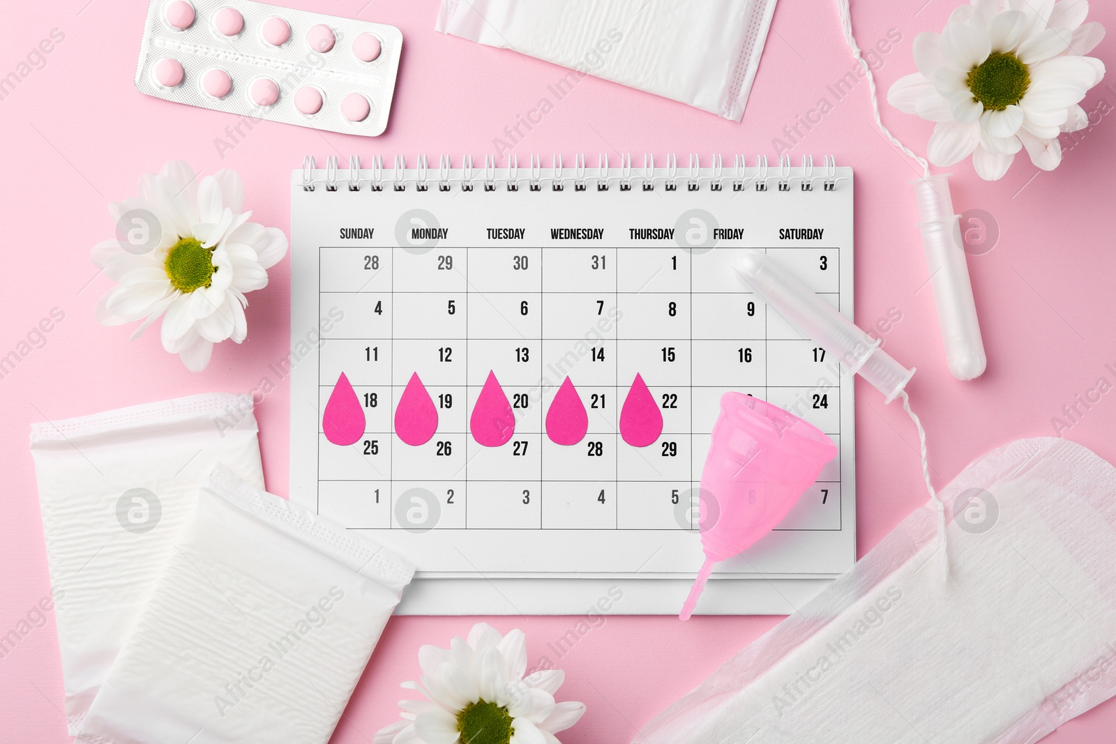 Photo of Flat lay composition with calendar and menstrual products on pink background