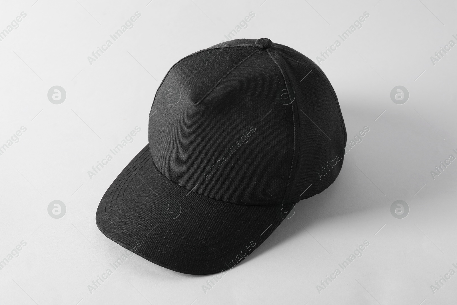 Photo of Stylish black baseball cap on light grey background. Mockup for design