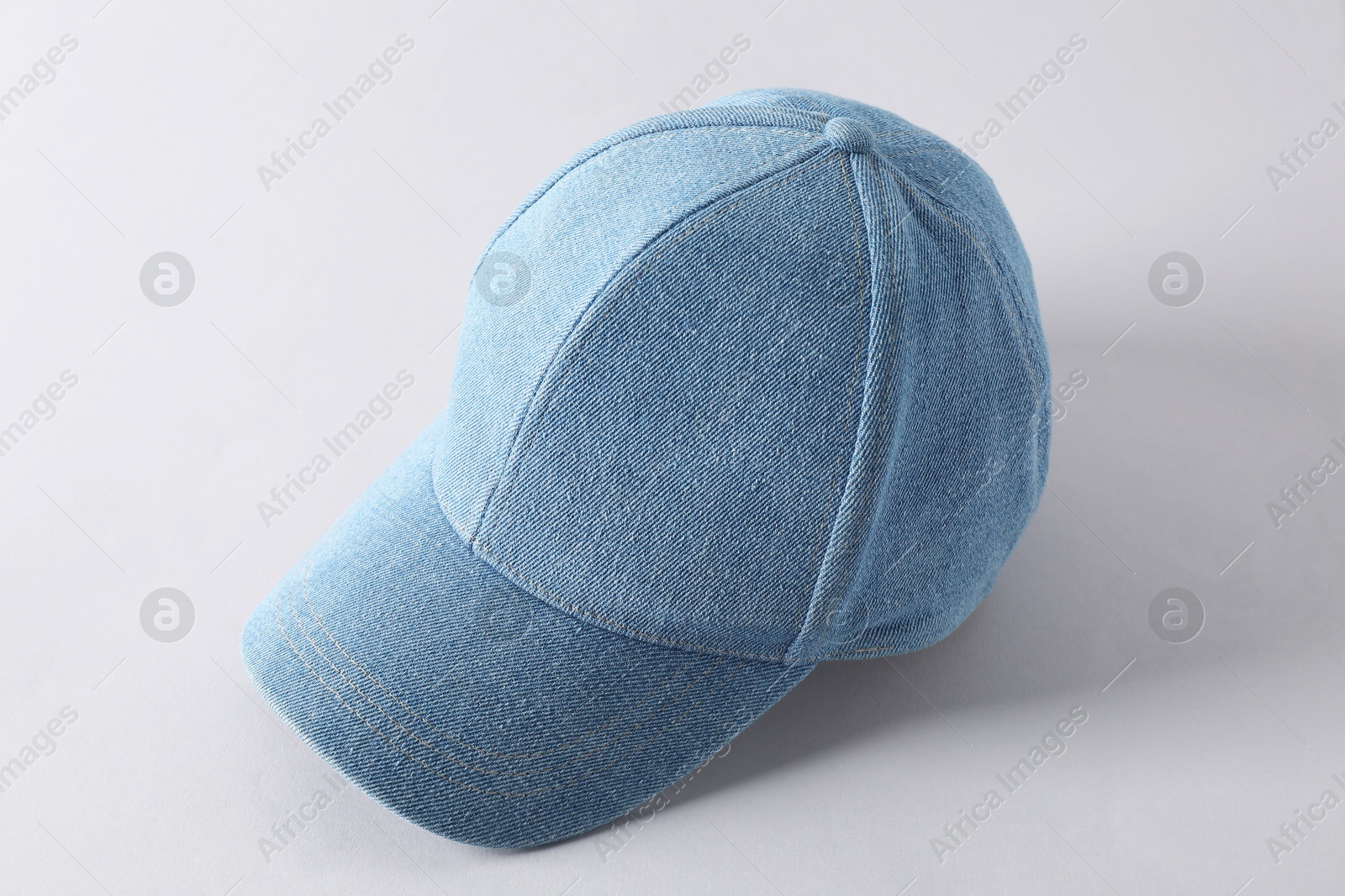 Photo of Stylish denim baseball cap on light grey background. Mockup for design