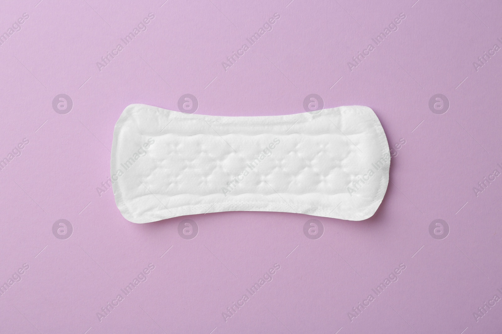 Photo of Menstrual pad on lilac background, top view