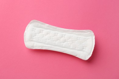 Photo of Menstrual pad on pink background, top view