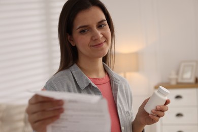 Woman with pills reading instruction at home