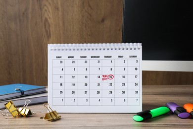 Timetable. Monthly planner, stationery and computer on wooden table