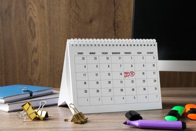 Timetable. Monthly planner, stationery and computer on wooden table