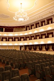 Photo of Rows of gray comfortable seats in theatre