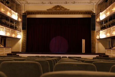 Photo of Theatre interior with stage and rows of comfortable seats