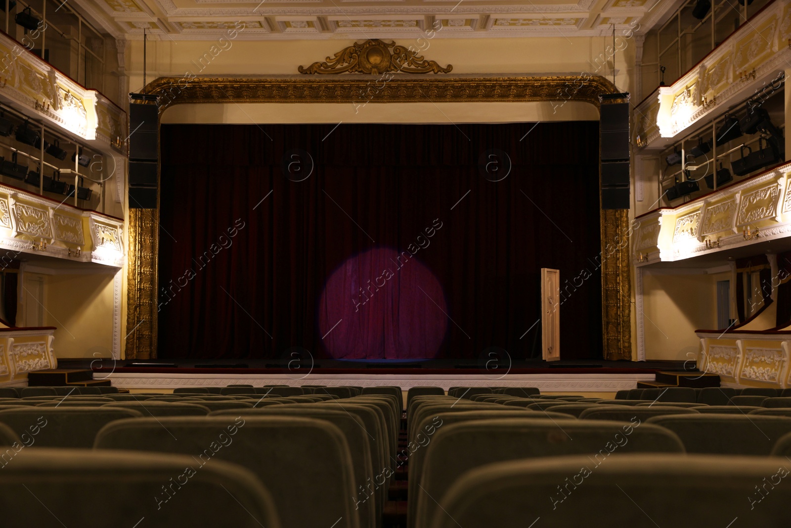 Photo of Theatre interior with stage and rows of comfortable seats