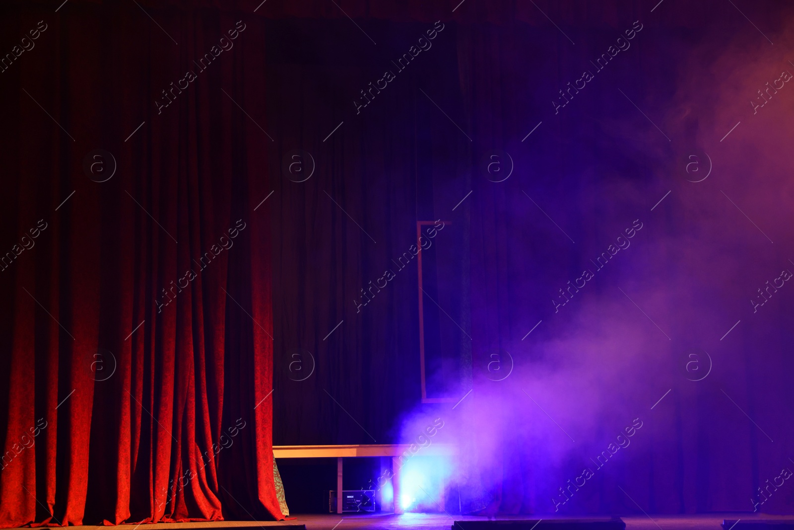 Photo of Professional spotlight and smoke on stage in theatre