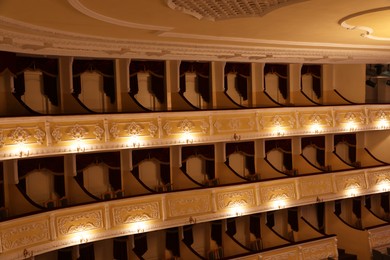 Photo of Balconies with comfortable chairs and vintage lamps in theatre