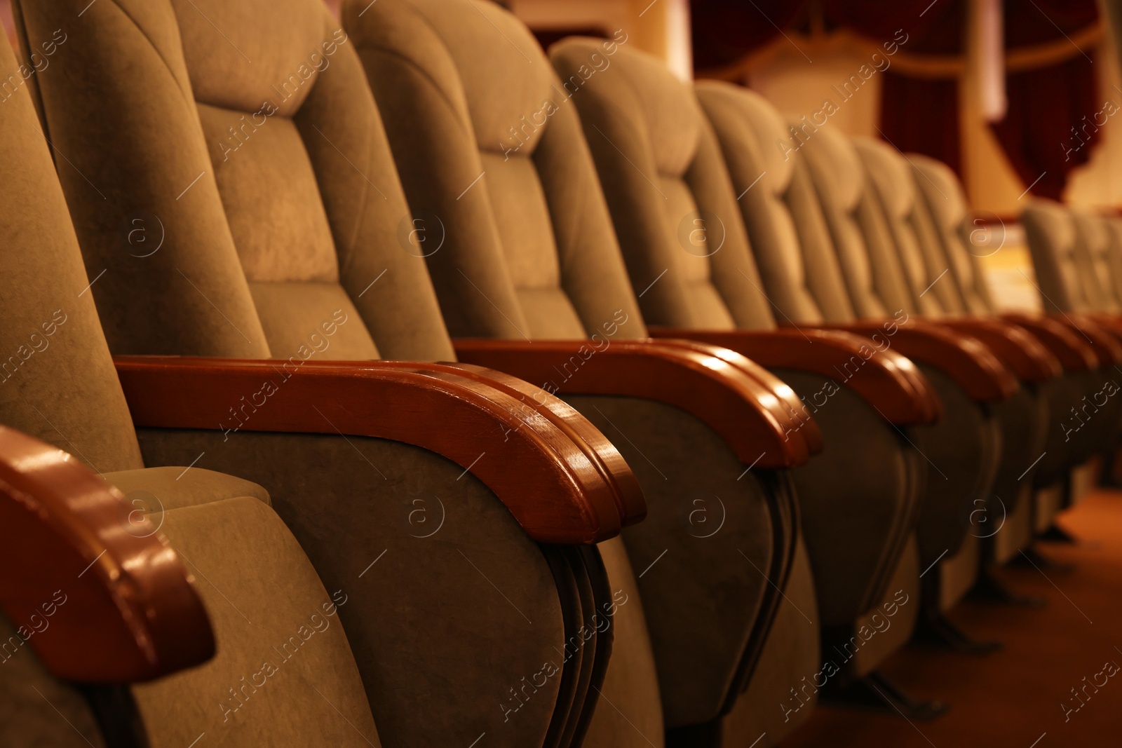 Photo of Row of gray comfortable seats in theatre, closeup